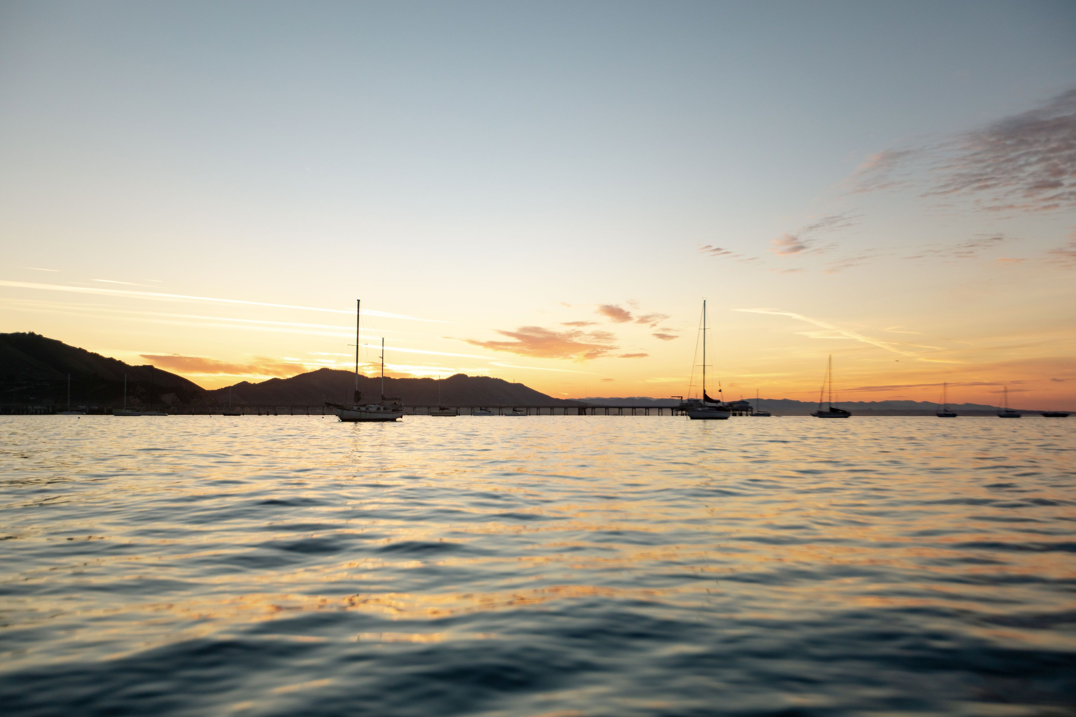 Peaceful harbor view with boats at sunset on California's central coast