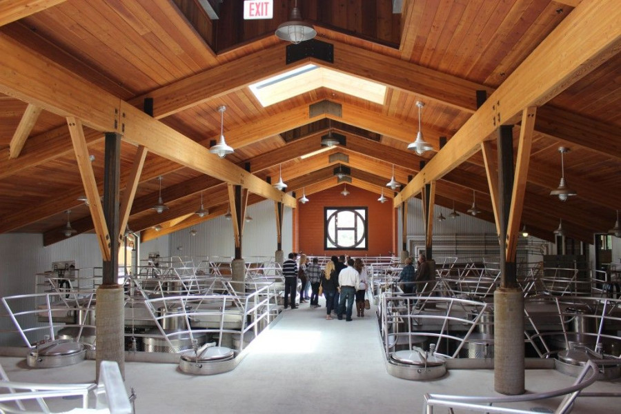 group of people walking through the production area of a winery in paso robles